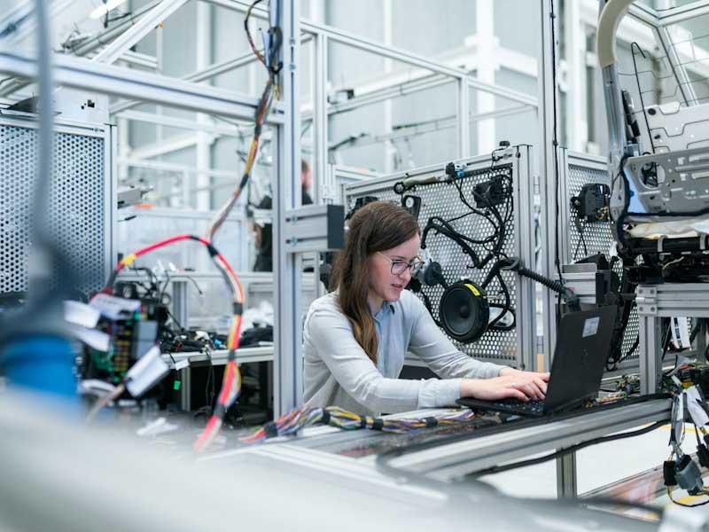 woman sitting at desk in a tech/engineer environment